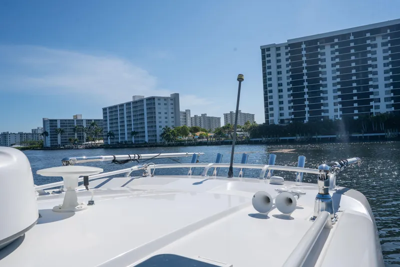 Slide: The Image of 2018 Pursuit OS 325 Offshore boat on water with cityscape background. - 44