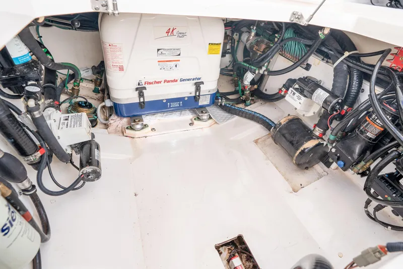 Slide: The Image of Engine compartment of a 2018 Pursuit OS 325 Offshore with Fischer Panda generator. - 46