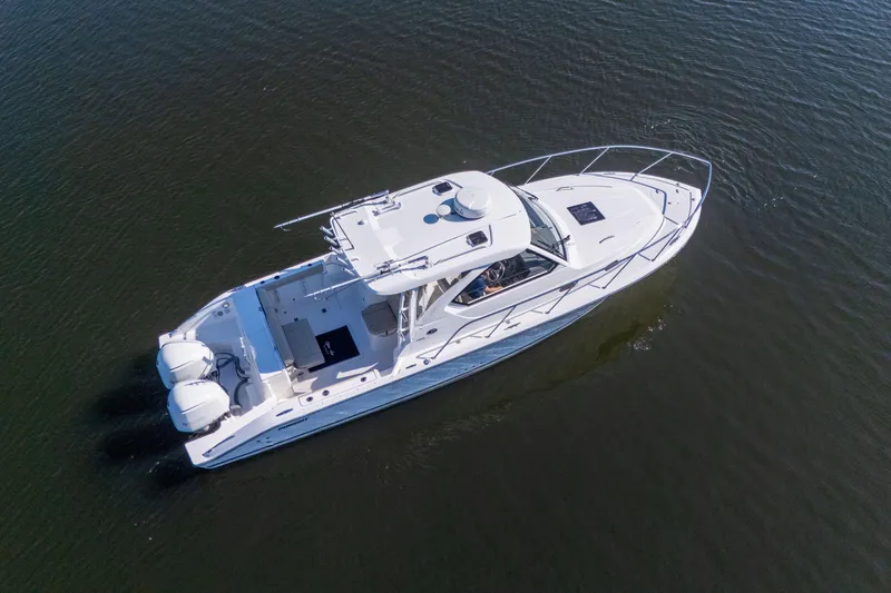 Slide: The Image of 2018 Pursuit OS 325 Offshore boat cruising on calm water, aerial view. - 5