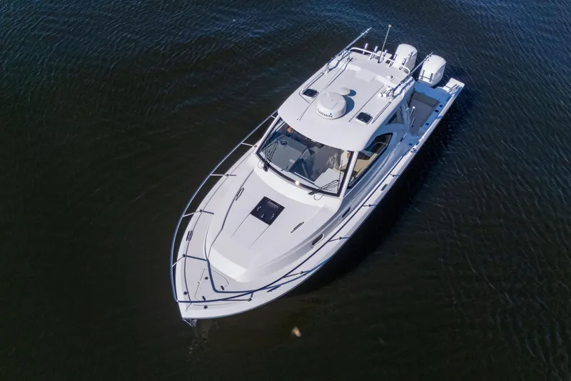 Slide: The Image of 2018 Pursuit OS 325 Offshore boat on calm water, aerial view. - 6