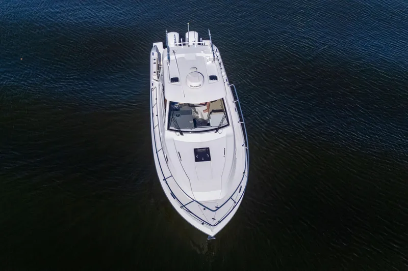 Slide: The Image of Aerial view of 2018 Pursuit OS 325 Offshore boat on calm water. - 7