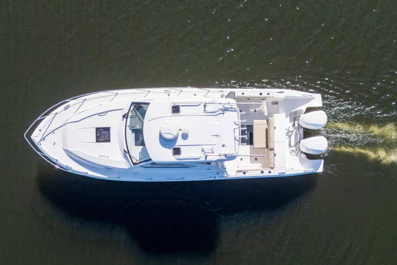 Slide: The Image of Aerial view of 2018 Pursuit OS 325 Offshore boat cruising on water. - 8