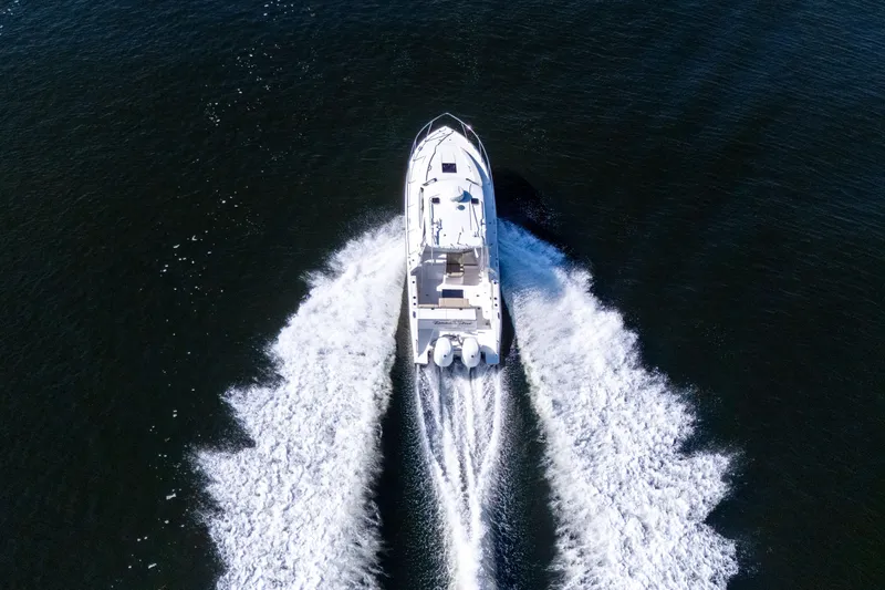 Slide: The Image of Aerial view of 2018 Pursuit OS 325 Offshore boat cruising on open water. - 9