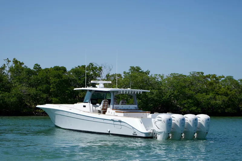 The Image of 2019 HCB 53 Suenos boat with four engines on a calm waterway. - 0