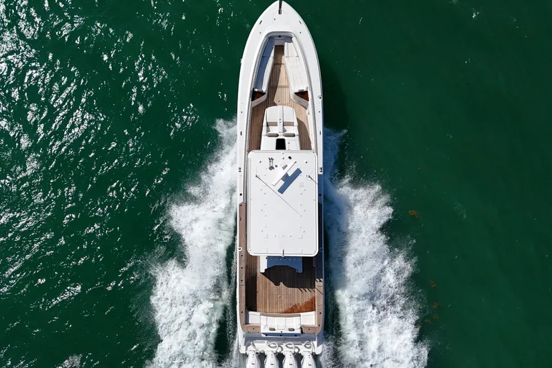 Slide: The Image of Top view of a 2019 HCB 53 Suenos boat cruising on green water. - 11
