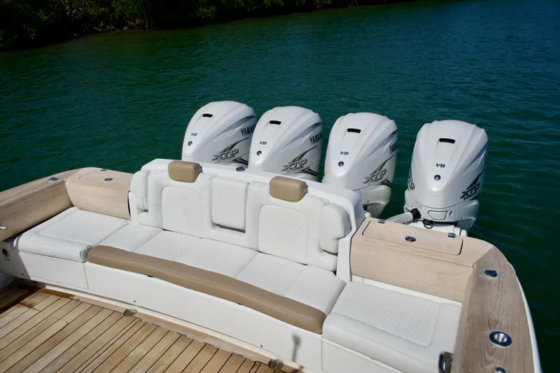 Slide: The Image of 2019 HCB 53 Suenos boat with four Yamaha V8 engines on a serene water backdrop. - 14