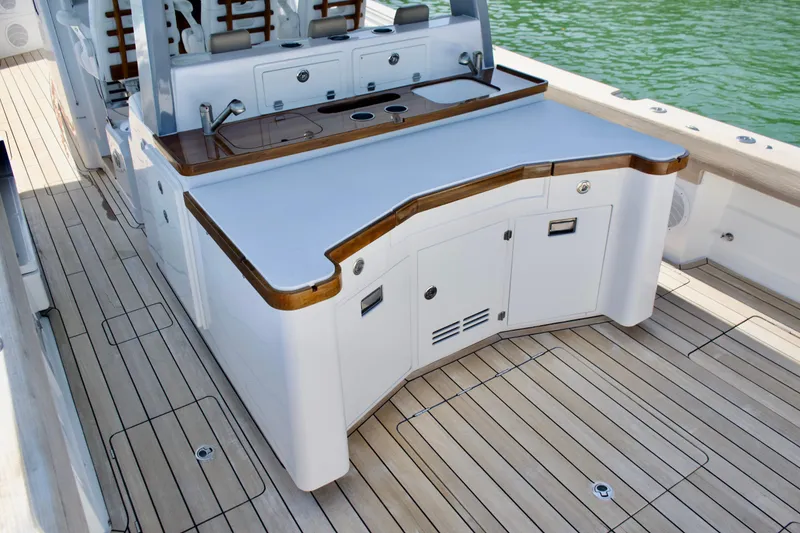 Slide: The Image of 2019 HCB 53 Suenos boat deck with sleek cabinetry and wood accents. - 15