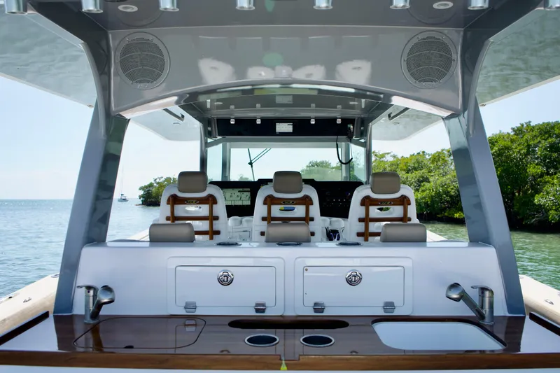 Slide: The Image of Interior view of 2019 HCB 53 Suenos boat with luxurious seating and control panel. - 19