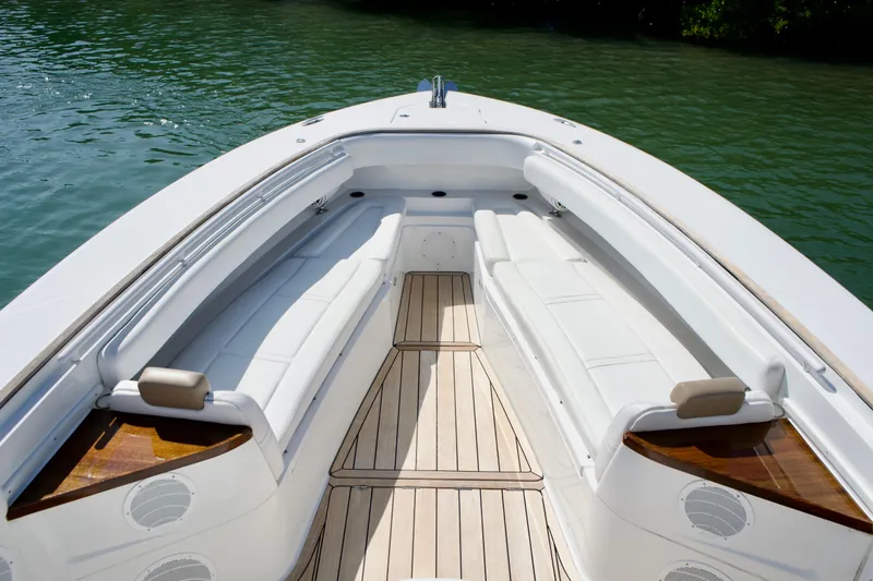Slide: The Image of 2019 HCB 53 Suenos boat interior with white seating and wooden deck. - 24