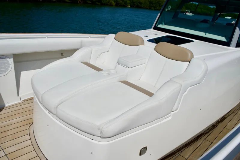 Slide: The Image of Luxurious seating on 2019 HCB 53 Suenos boat, featuring white leather upholstery and teak decking. - 28