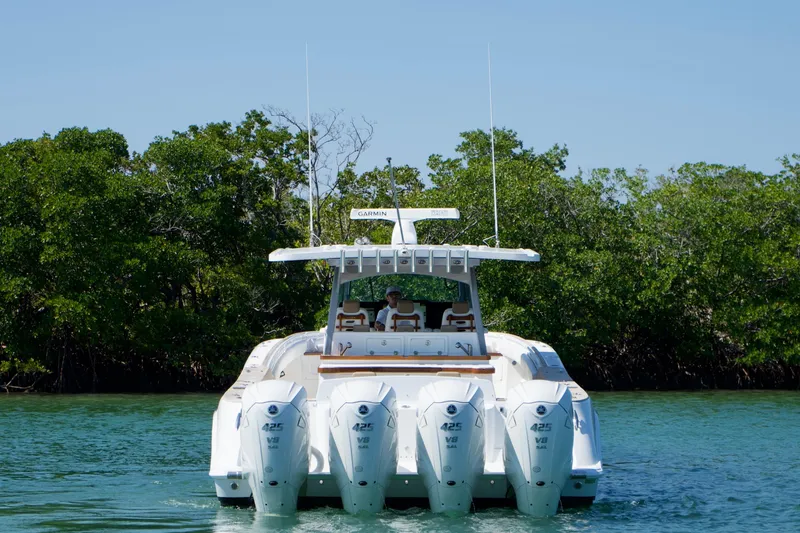 Slide: The Image of 2019 HCB 53 Suenos boat with four outboard engines on a calm waterway. - 3