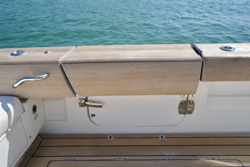 Slide: The Image of 2019 HCB 53 Suenos boat deck with wooden railing and ocean view. - 31