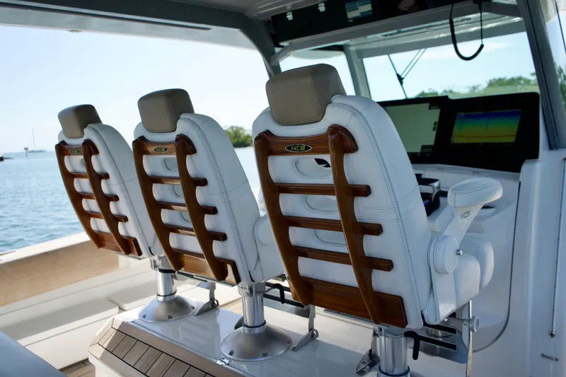 Slide: The Image of Luxury seating on 2019 HCB 53 Suenos boat with wooden accents and modern controls. - 34