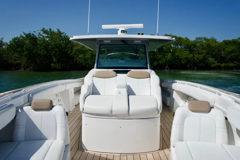 Slide: The Image of 2019 HCB 53 Suenos boat interior with white seating and wooden deck. - 36