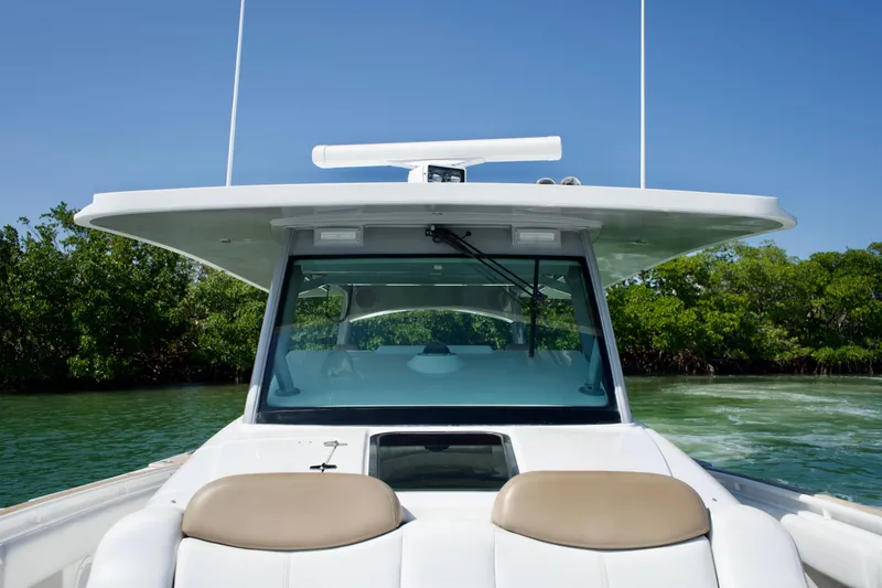 Slide: The Image of 2019 HCB 53 Suenos boat on water, featuring sleek design and modern cockpit. - 37