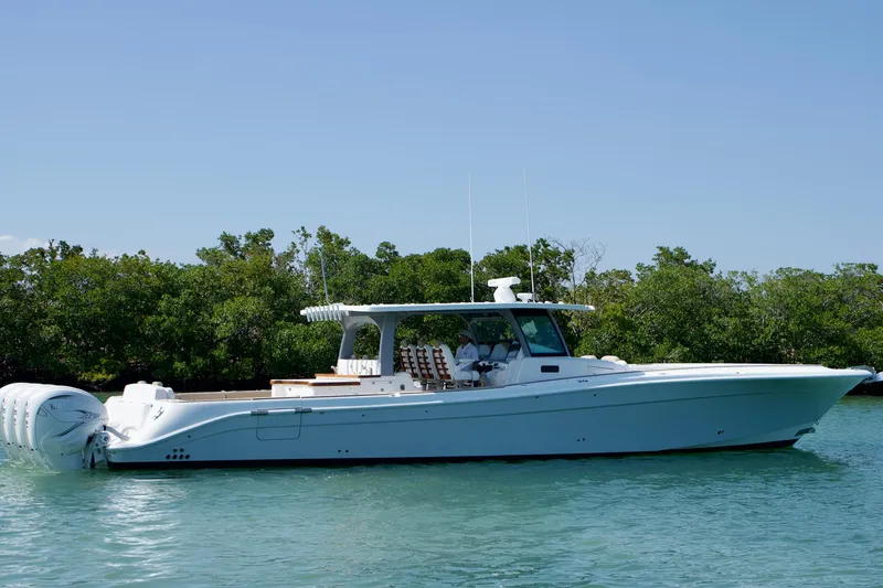 Slide: The Image of 2019 HCB 53 Suenos boat on calm water with lush greenery background. - 5