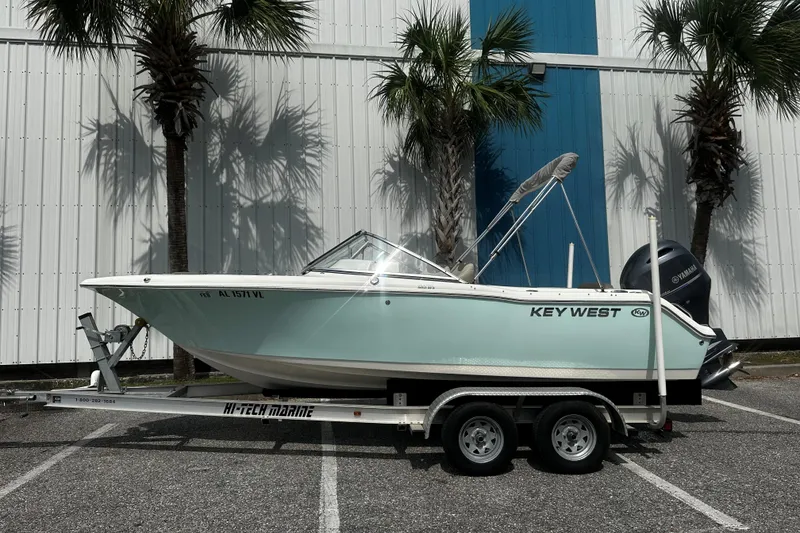 The Image of 2022 Key West 203 DFS boat on trailer, parked near palm trees. - 1