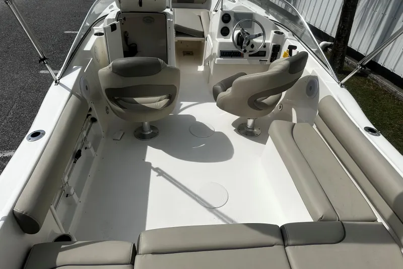 Slide: The Image of 2022 Key West 203 DFS boat interior with seating and steering wheel. - 4