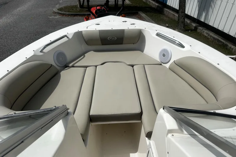 Slide: The Image of 2022 Key West 203 DFS boat interior with beige seating and speakers. - 6