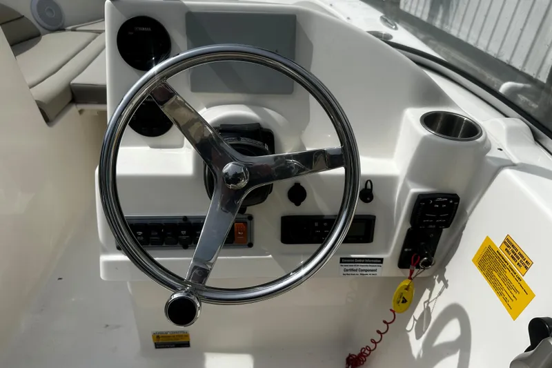 Slide: The Image of Steering console of 2022 Key West 203 DFS boat with chrome wheel and controls. - 7