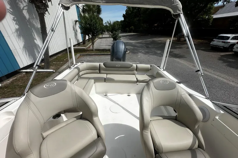 Slide: The Image of 2022 Key West 203 DFS boat interior with beige seating and canopy. - 8