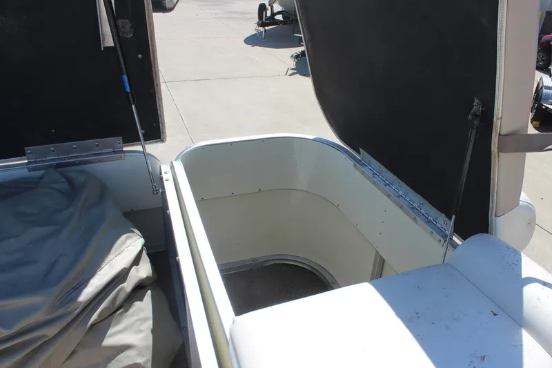 Slide: The Image of Open storage compartment on a 2002 Bennington 2575FS boat, showing interior details. - 10