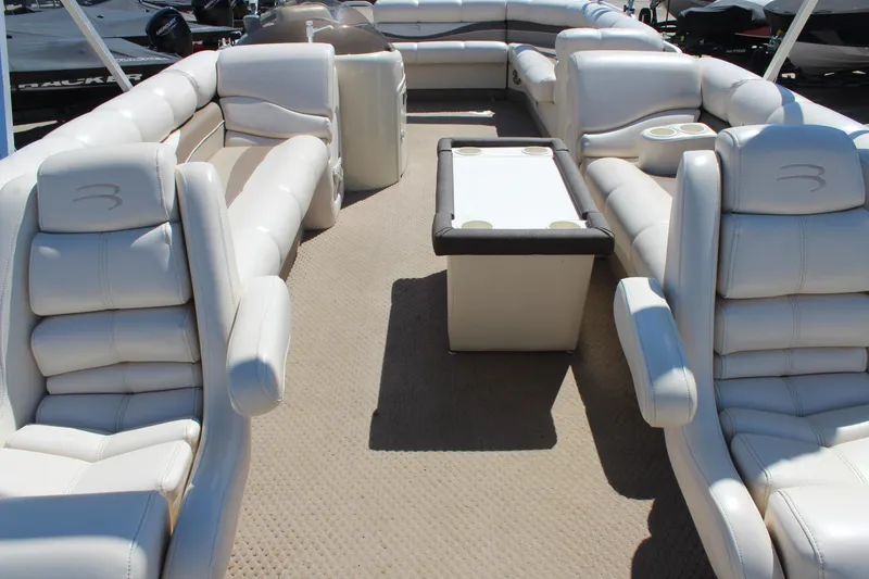 Slide: The Image of Luxurious interior of a 2002 Bennington 2575FS pontoon boat with plush seating and table. - 11