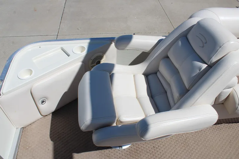 Slide: The Image of Luxurious seating on a 2002 Bennington 2575FS boat, featuring plush white upholstery. - 12