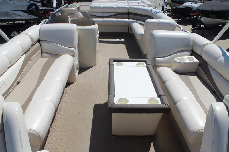 Slide: The Image of 2002 Bennington 2575FS pontoon boat interior with spacious seating and table. - 14