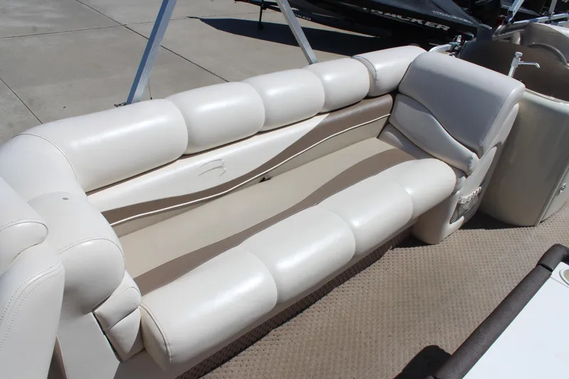 Slide: The Image of Luxurious seating on a 2002 Bennington 2575FS pontoon boat, featuring plush white upholstery. - 15