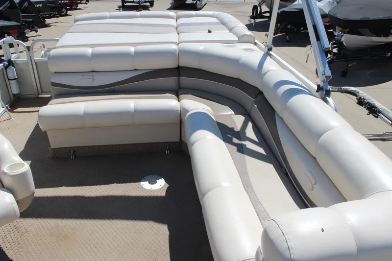 Slide: The Image of 2002 Bennington 2575FS pontoon boat with spacious beige seating area. - 17