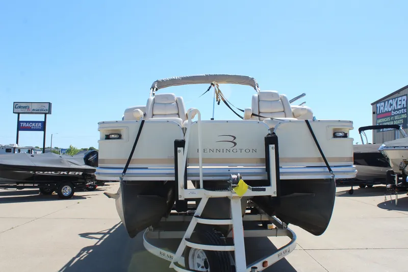 Slide: The Image of 2002 Bennington 2575FS pontoon boat on trailer at dealership. - 2