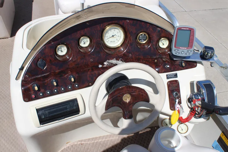 Slide: The Image of Dashboard of a 2002 Bennington 2575FS boat with gauges and controls. - 20