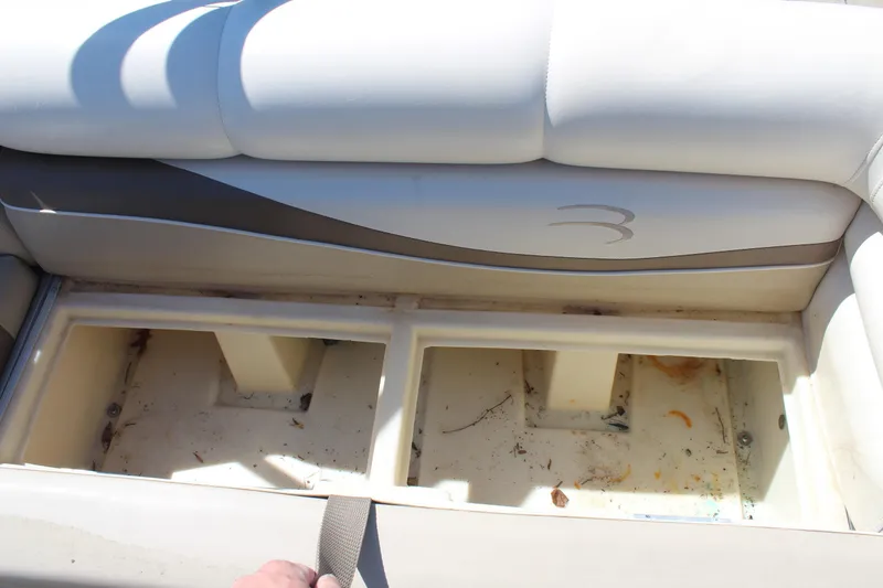 Slide: The Image of Open storage compartment in a 2002 Bennington 2575FS boat seat. - 23