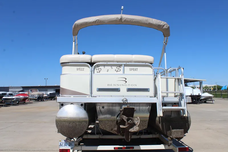 Slide: The Image of 2002 Bennington 2575FS pontoon boat on trailer, rear view with ladder and canopy. - 6