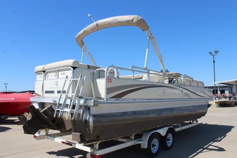 Slide: The Image of 2002 Bennington 2575FS pontoon boat on trailer under clear blue sky. - 7