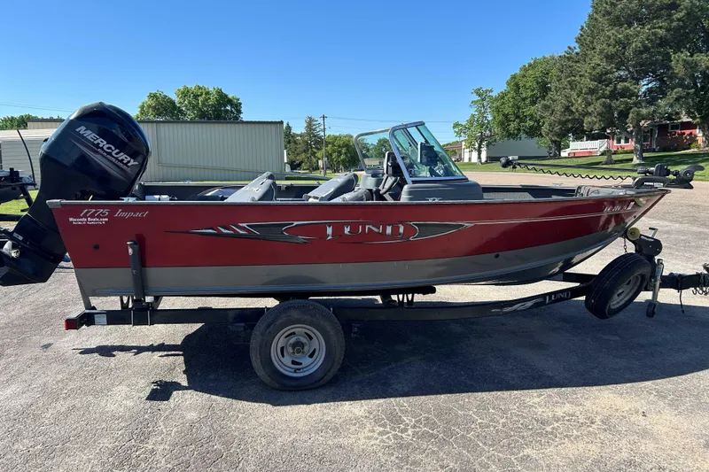Slide: The Image of 2013 Lund 1775 Impact XS boat on trailer, featuring a Mercury outboard motor. - 3