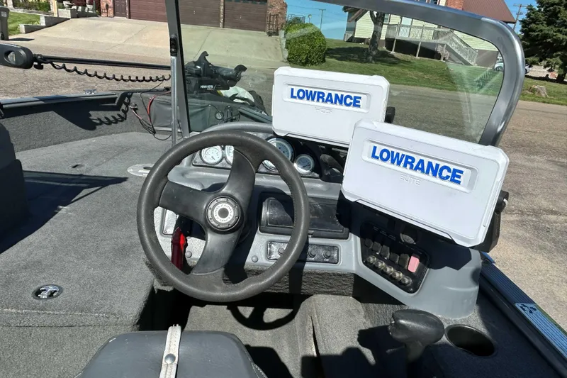 Slide: The Image of 2013 Lund 1775 Impact XS boat dashboard with Lowrance fish finders and steering wheel. - 5