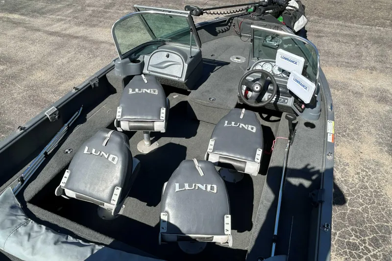 Slide: The Image of 2013 Lund 1775 Impact XS boat interior with seating and steering console. - 9