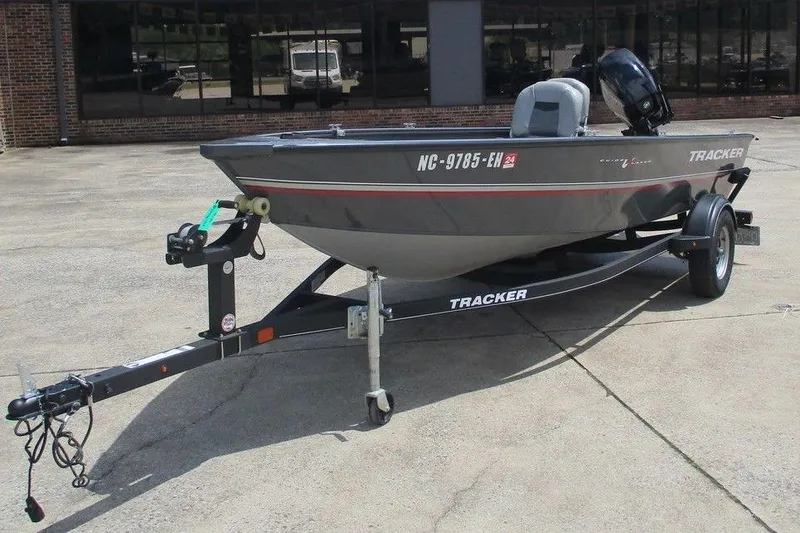 Slide: The Image of A 2014 Bass Cat Puma FTD boat on a trailer in a parking lot. - 3
