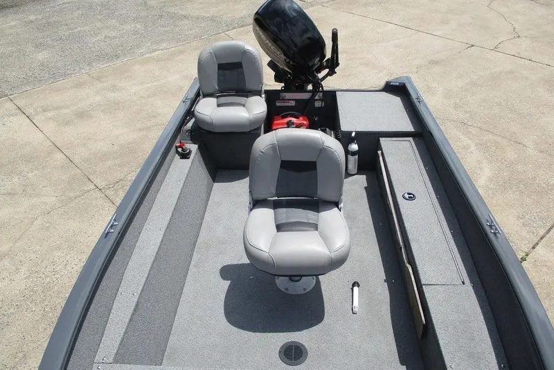 Slide: The Image of 2014 Bass Cat Puma FTD boat interior with two gray seats and motor. - 4