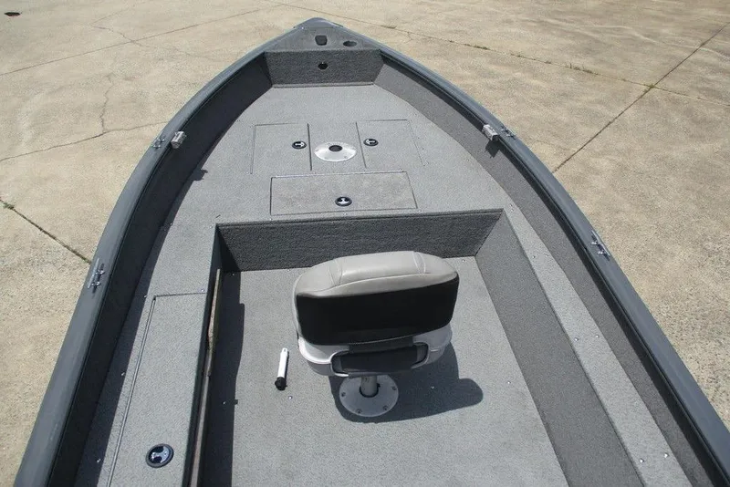 Slide: The Image of 2014 Bass Cat Puma FTD boat interior with gray seating and storage compartments. - 6