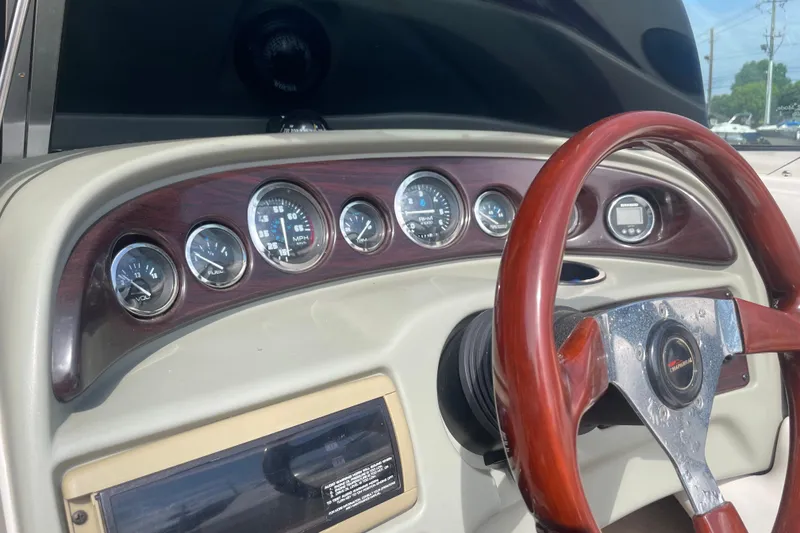 Slide: The Image of 1999 Chaparral 1830 SS dashboard with gauges and wooden steering wheel. - 11