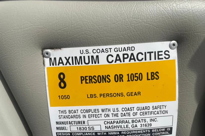 Slide: The Image of 1999 Chaparral 1830 SS capacity label, 8 persons or 1050 lbs, U.S. Coast Guard compliant. - 12
