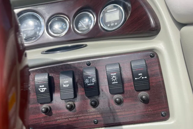 Slide: The Image of Dashboard controls of a 1999 Chaparral 1830 SS boat with switches and gauges. - 13