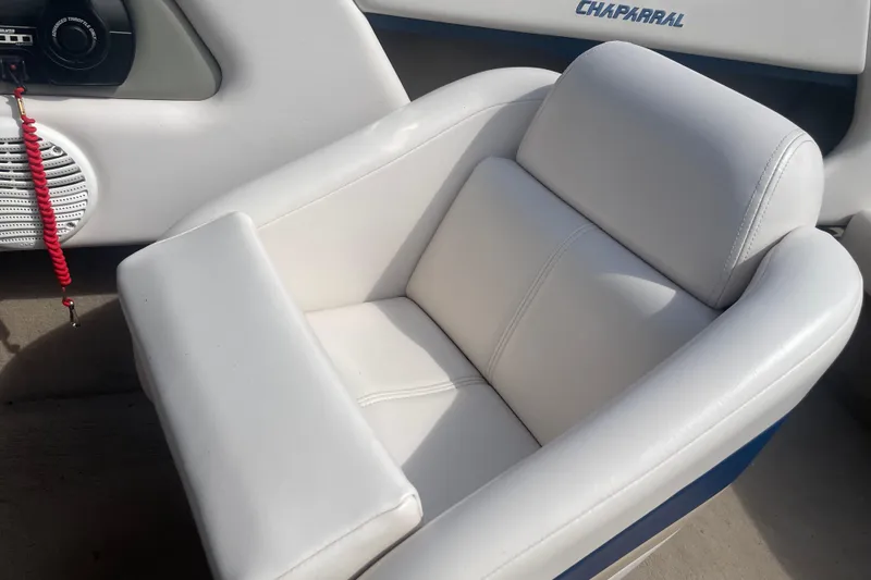 Slide: The Image of White leather seat in a 1999 Chaparral 1830 SS boat interior. - 14