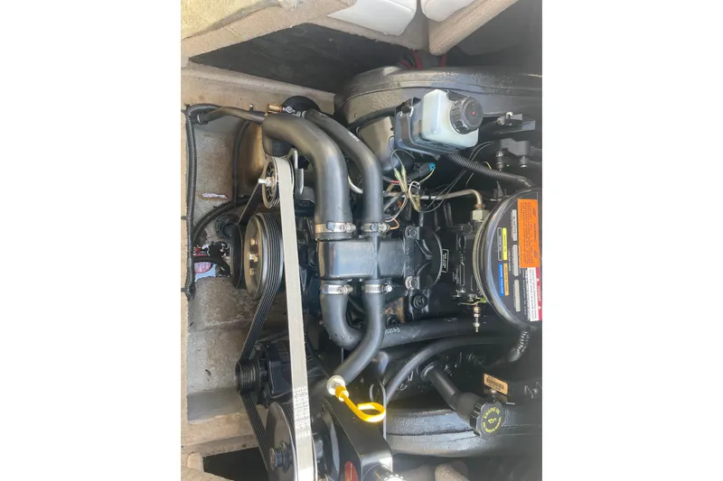 Slide: The Image of Engine compartment of a 1999 Chaparral 1830 SS boat, showing detailed components. - 15