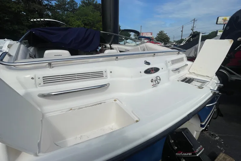Slide: The Image of 1999 Chaparral 1830 SS boat, rear view with open storage compartments and visible seating. - 6