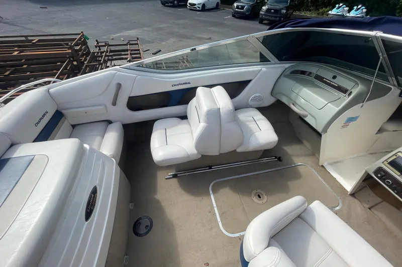 Slide: The Image of 1999 Chaparral 1830 SS boat interior with white seating and dashboard view. - 9