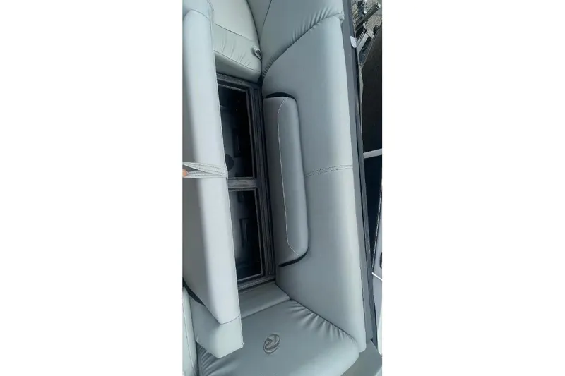 Slide: The Image of 2018 Lowe Retreat 250 RFL boat interior with gray cushioned seating and storage compartment. - 6